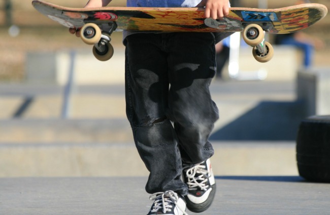 Child carrying skateboard