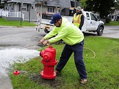 worker turning on fire hydrant